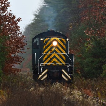 a train on a track with smoke coming out of it