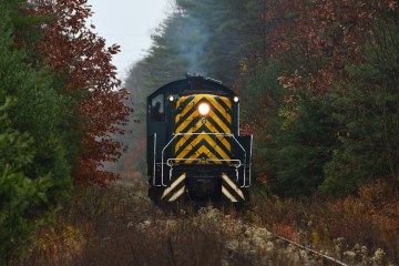 a train on a track with smoke coming out of it