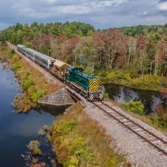 a train traveling down train tracks next to a river
