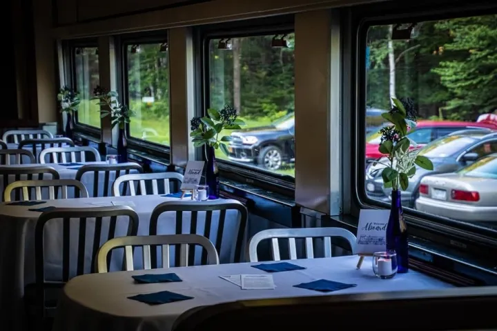 a dining room table in front of a window