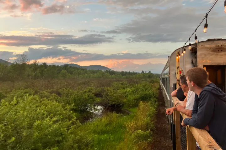 a man standing in front of a mountain
