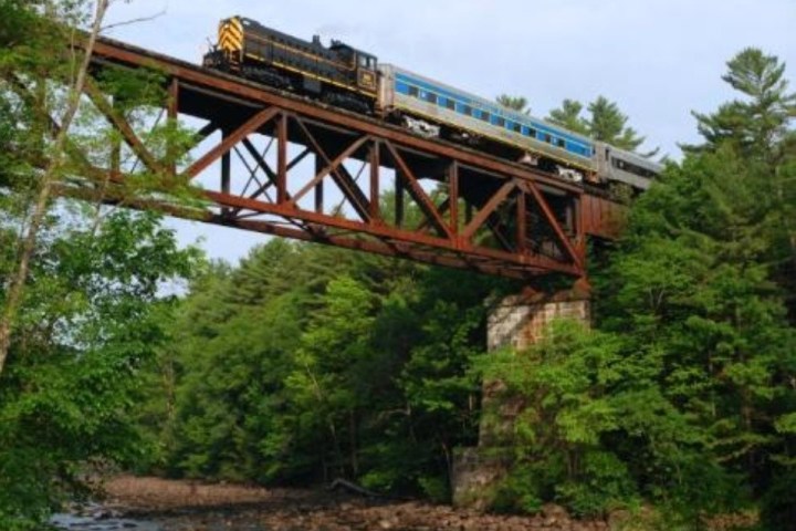 a train crossing a bridge over a river