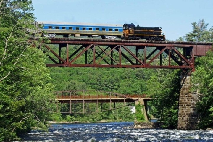 a train crossing a bridge over a river