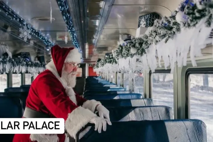 Santa Claus inside a festively decorated train with icicles and garlands.