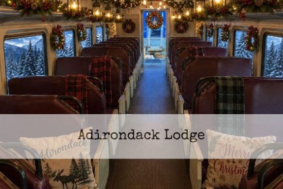 Interior of decorated train car with holiday wreaths and garlands.