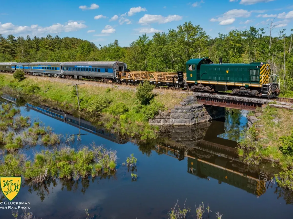 a train crossing a bridge over a river