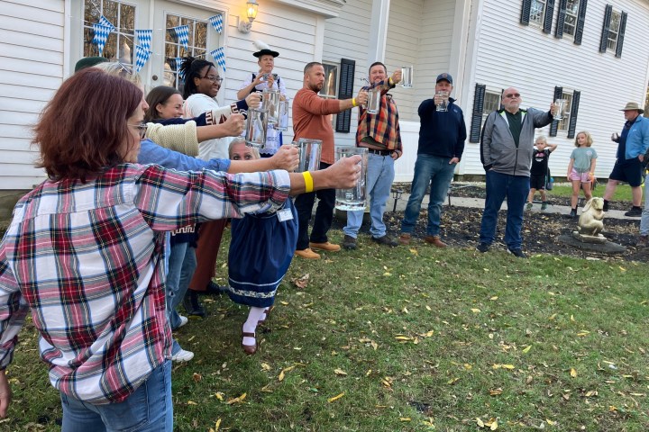 a group of people that are standing in the grass