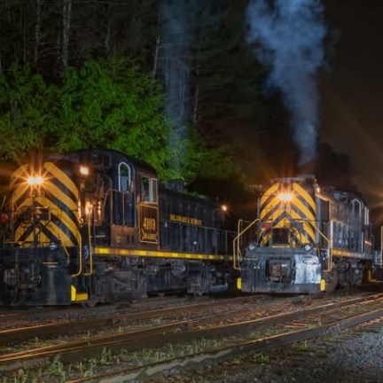 a train on a track with smoke coming out of it