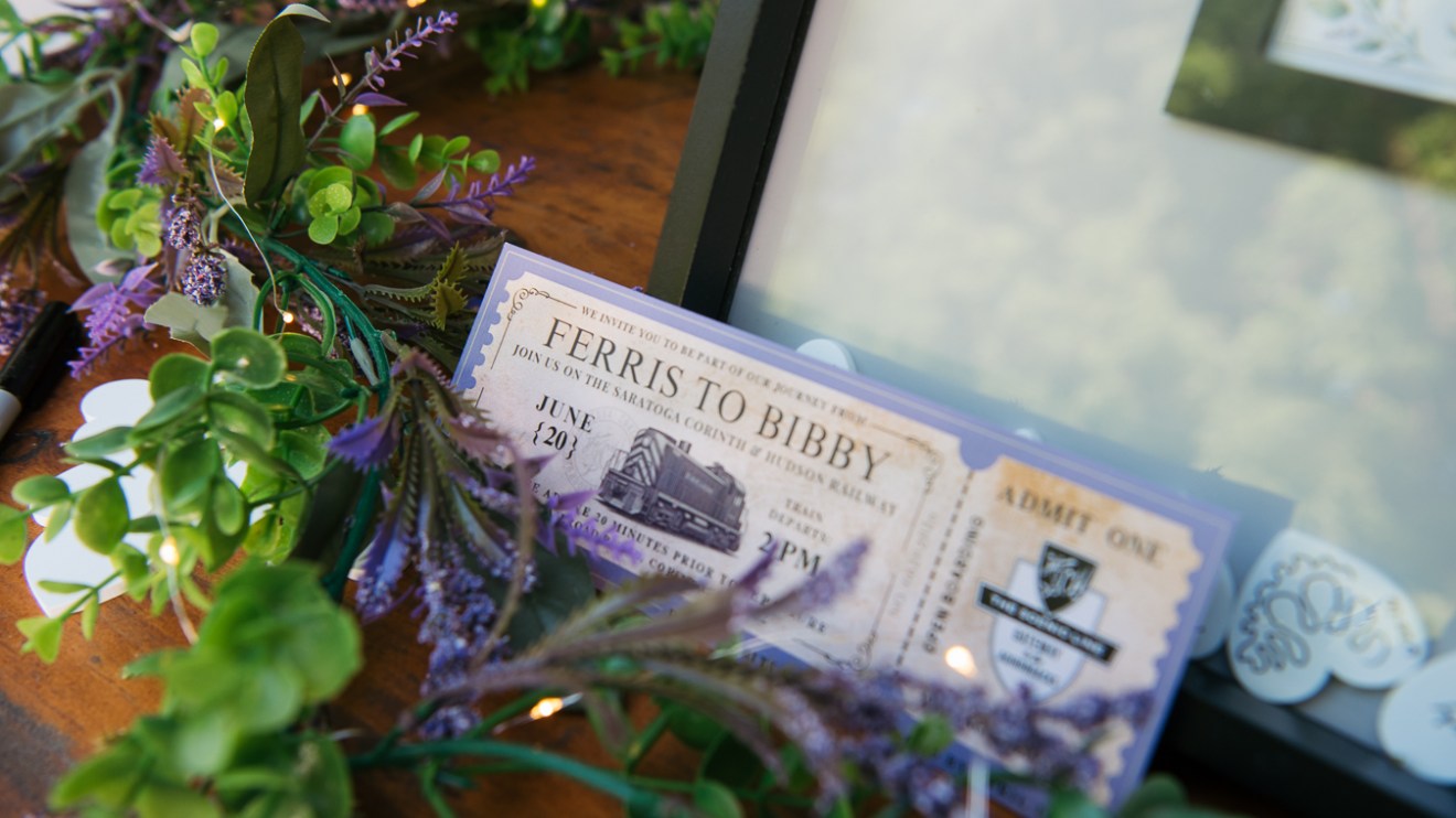 Vintage train ticket on a decorative leafy surface.